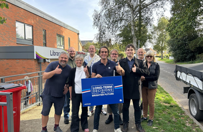 Alex Clarkson with a team of Conservative activists. In the background is Knebworth library and some trees.