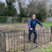 Alex Clarkson standing in a derelict children's playground looking concerned. 