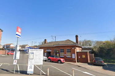 Knebworth train station and car park with a few cars parked in it.