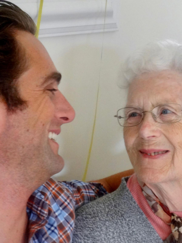 Alex Clarkson and his late nan looking at each other and smiling.