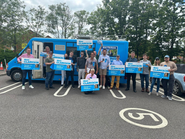 Alex Clarkson with supporters and his battle bus